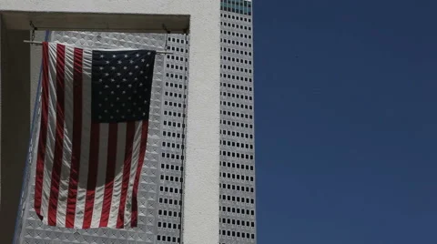American Flag In Front Of A Skyscraper In Downtown Dallas
