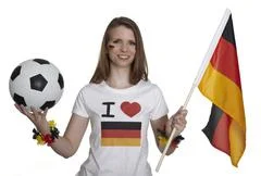 Attractive Woman Shows German Flag And Football And Smiles In Front Of White 