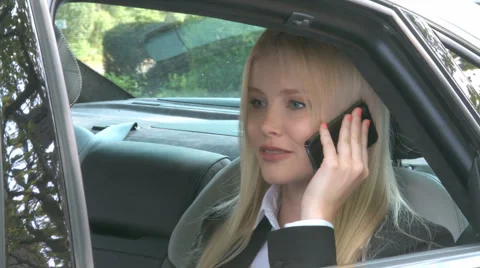 Business Woman Receives Call In Limousine