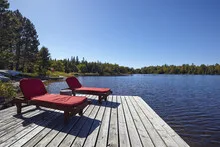 Wooden chairs overlooking a lake