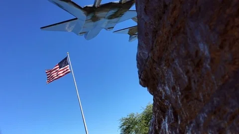 Us Flag In Slowmotion With Aircraft Silhouette