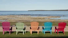 4K Time lapse shadow over colored chairs at lake
