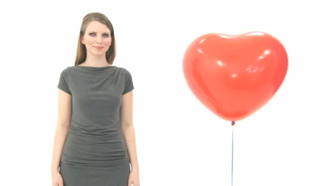 Woman Standing Next To Lifting Heart Balloon