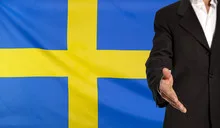 Open hand and Sweden flag in the background
