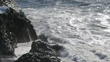 Slowmotion waves crashing on rock coast