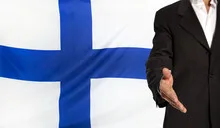 Open hand and Finland flag in the background