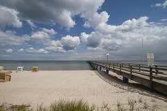 Wooden Pier Over The Baltic Sea With Clouds