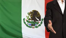 Open hand and Mexico flag in the background