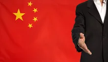 Open hand and China flag in the background