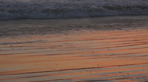 Tide Waves On The Beach At Sunset