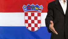 Open hand and Croatia flag in the background