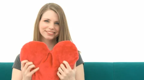 Woman On Sofa Cuddling Heart Pillow