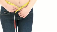 Woman measuring her waist