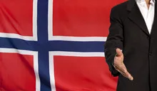 Open hand and Norway flag in the background