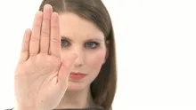 Woman raises hand / stop expression