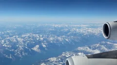 Aerial Plane View With Mountains In The Background Looking Out Of A Plane Window