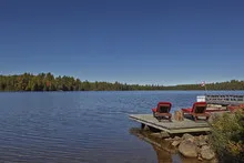 Wooden chairs overlooking a lake