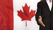 Open hand and Canada flag in the background