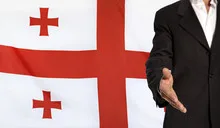 Open hand and Georgia flag in the background