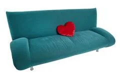 Green Sofa With Red Heart Shaped Pillow Lying On The Middle Of The Couch