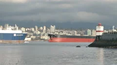 Cargo Ships Passing A Lighthouse In Vancouver, Canada