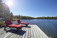 Wooden chairs overlooking a lake