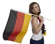 Attractive Woman Shows German Flag And Smiles In Front Of White Background