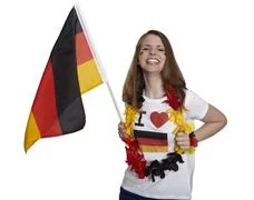 Attractive Woman Shows German Flag And Smiles In Front Of White Background