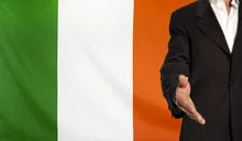 Open hand and Republic of Ireland flag in the background